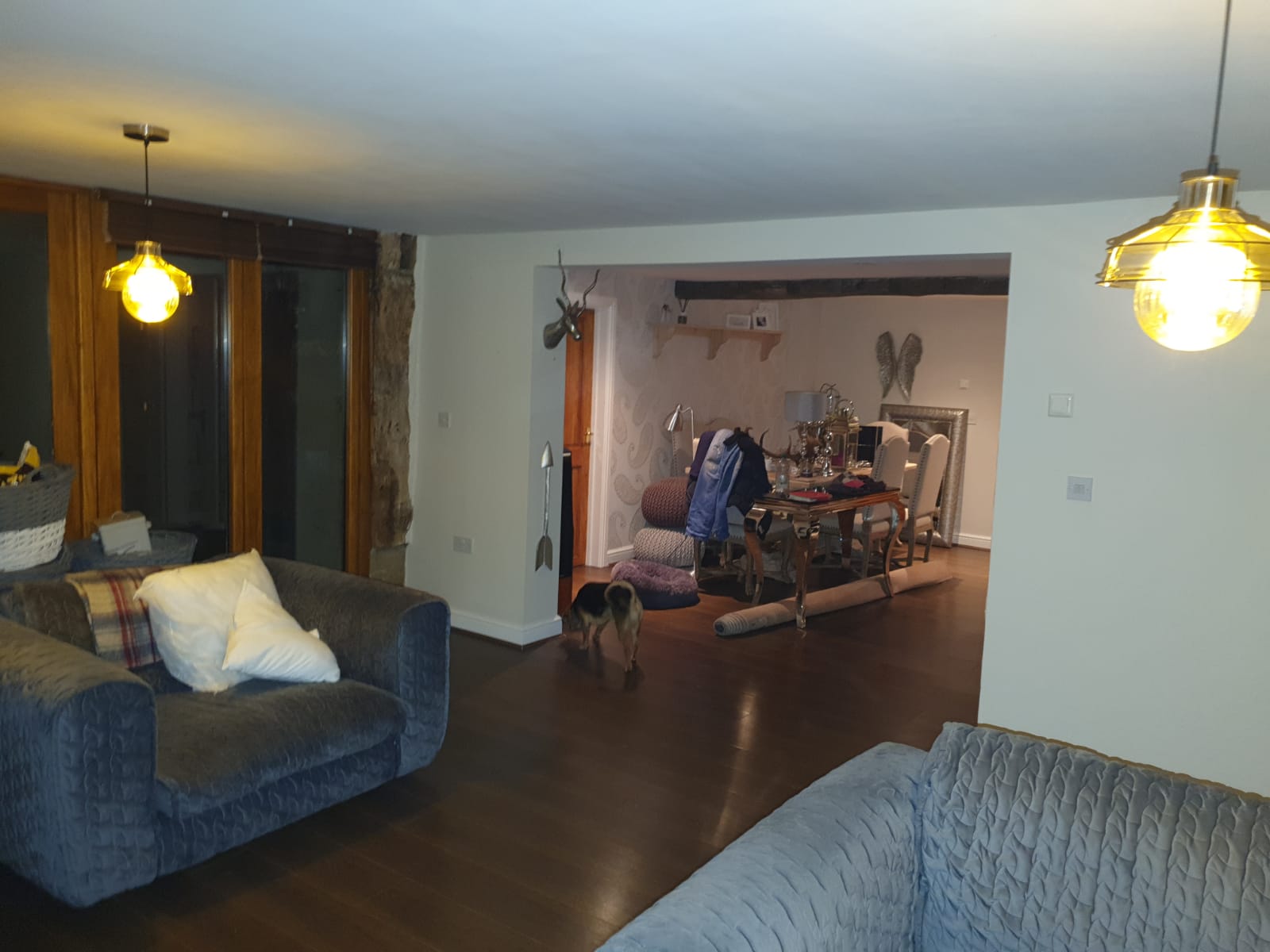 Large open plan Sheffield interior with painted ceilings, neutral walls, dark oak floor and dining area beyond. Painter and decorator project by Richard Walton.