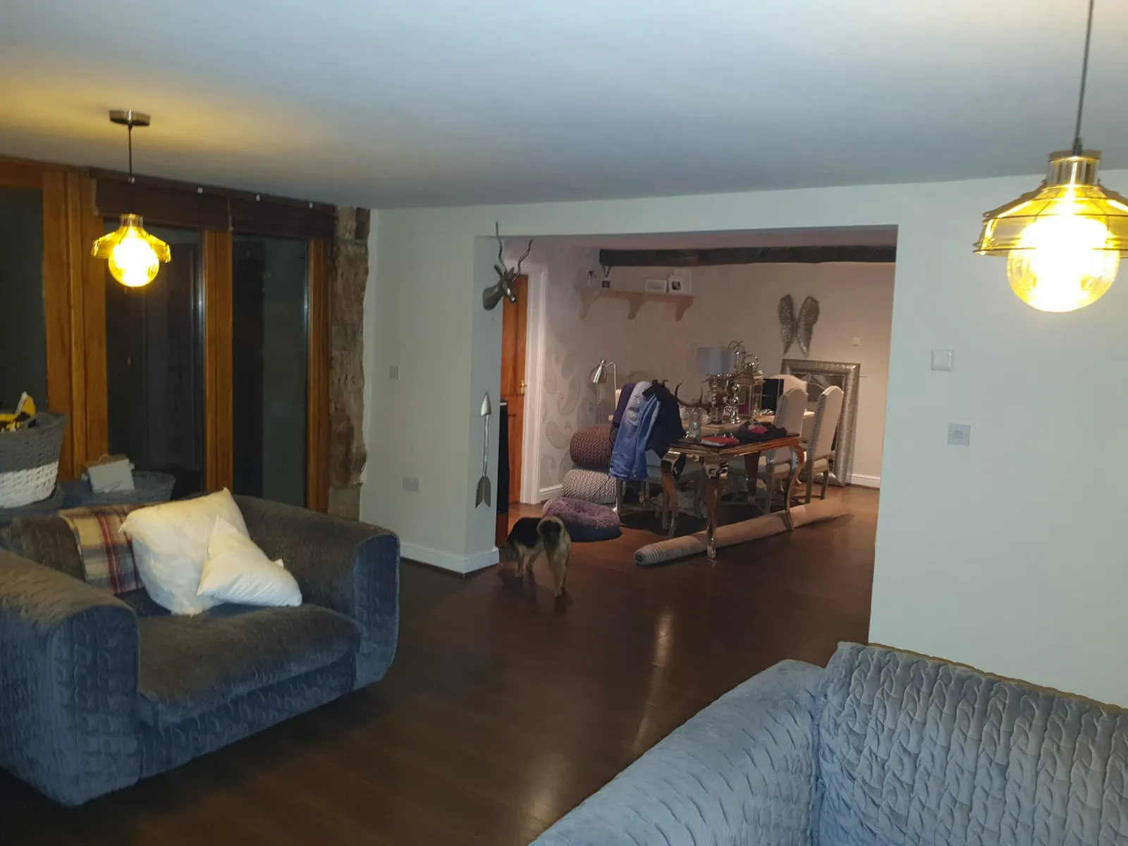 Large open plan Sheffield interior with painted ceilings, neutral walls, dark oak floor and dining area beyond. Painter and decorator project by Richard Walton.